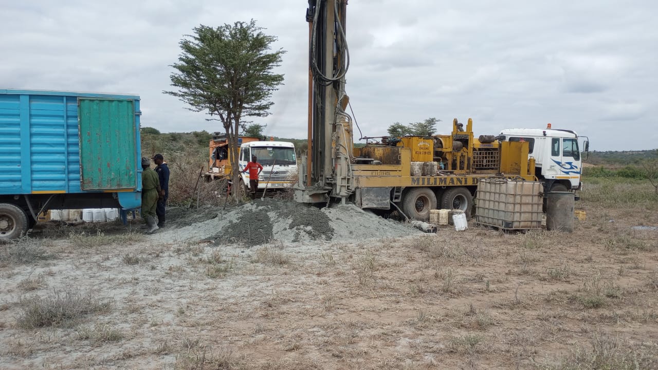 Milimani Drilling heavy DTH rig and support trucks on site in Kenya